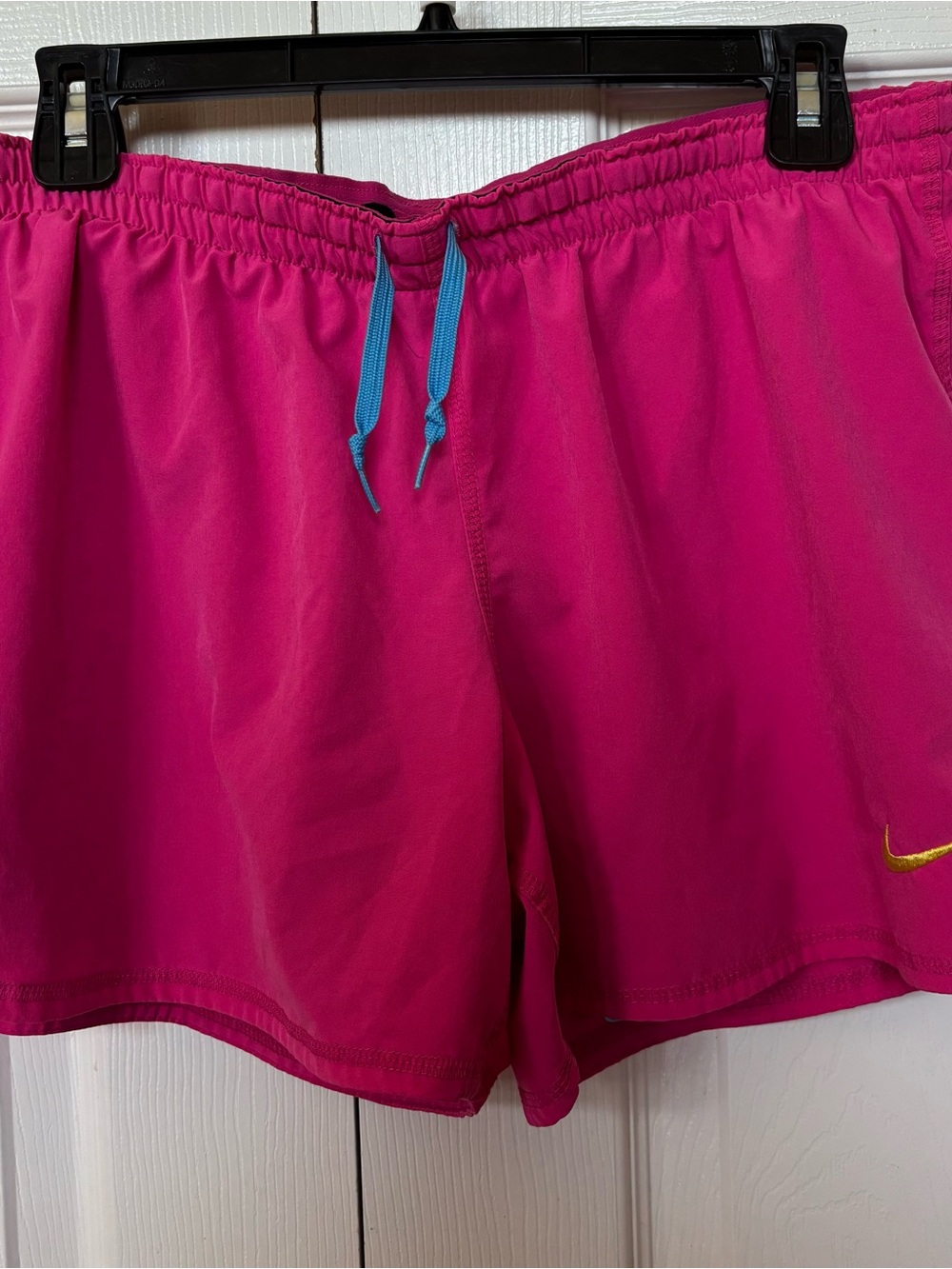 Nike Women's Hot Pink Athletic Shorts with Blue Drawstring and Gold Swoosh